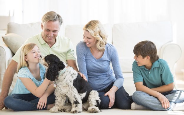 Family Sitting on Floor with Spaniel Dog | Heating and Cooling Plan Benefits | Keith Air