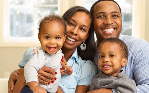 Father, mother, toddler and baby with smiles | Good Indoor Air Quality Depends on the Right Heating and Air Services | Keith Air Conditioning